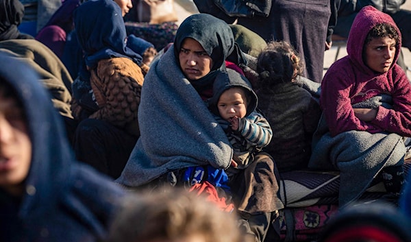 لاجئون أكراد فارون من حلب لدى وصولهم إلى مدينة الطبقة (أ ف ب)