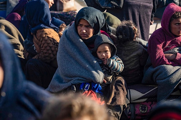 لاجئون أكراد فارون من حلب لدى وصولهم إلى مدينة الطبقة (أ ف ب)