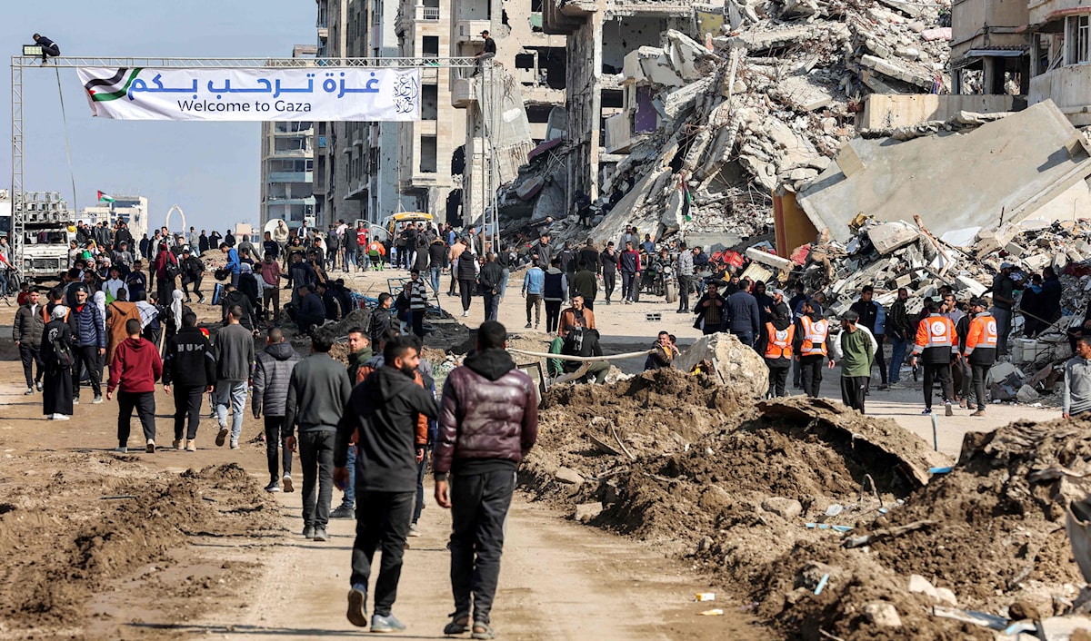 افترش غزيون الأرض على مدخل وادي غزة، في انتظار انسحاب الجيش الإسرائيلي من حاجز نتساريم (أ ف ب)