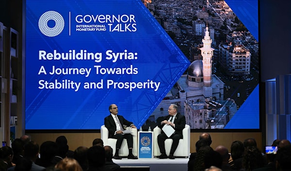 وزير المالية السوري، محمد يسر برنية، يتحدث عن إعادة إعمار سوريا خلال اجتماعات البنك الدولي وصندوق النقد الدولي في واشنطن (أ ف ب)