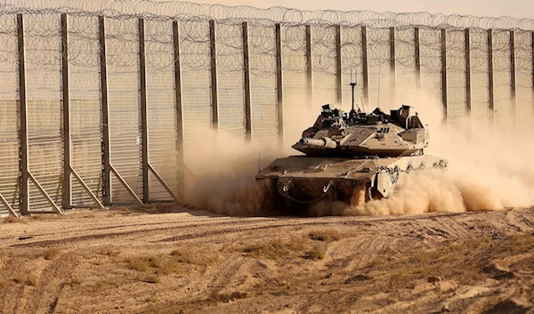 دبابة لجيش الاحتلال الإسرائيلي تتحرك على طول السياج الحدودي مع قطاع غزة (أ ف ب)