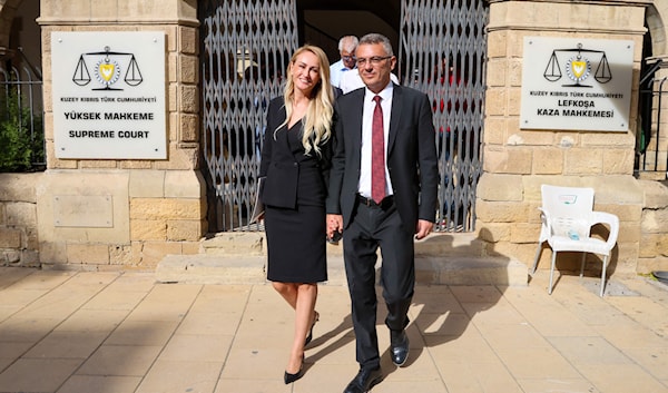 الرئيس طوفان إرهومان وزوجته لدى مغادرتهما مقر المحكمة العليا في الجانب القبرصي التركي من نيقوسيا (أ ف ب)