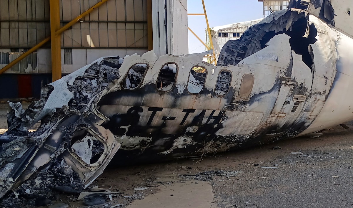 حطام طائرة مدنية في مطار الخرطوم تضرّرت بفعل المعارك بين الجيش و«الدعم السريع» (أ ف ب)