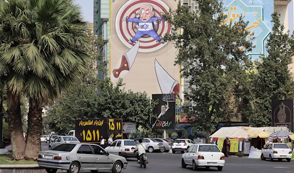 رسم يسخر من رئيس وزراء العدو، بنيامين نتنياهو، في طهران (أ ف ب)