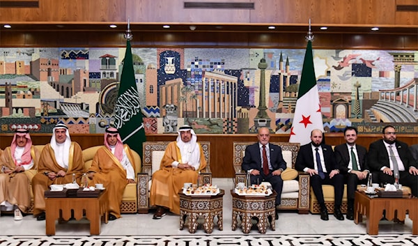 الوفد السعودي مع وزراء من الحكومة السورية (أ ف ب)